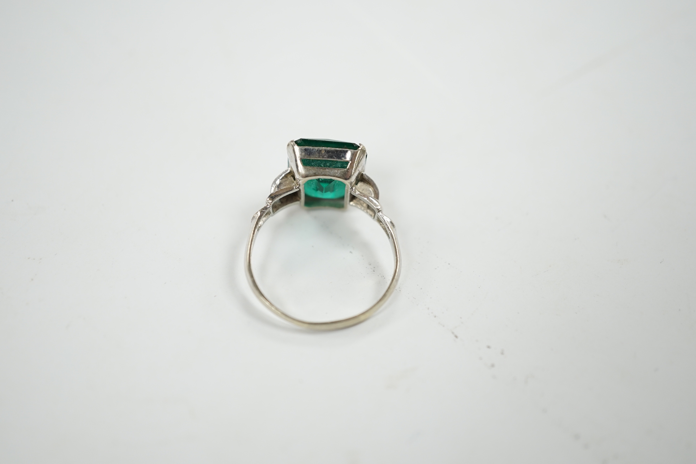 A 14k and single stone green paste set ring, with diamond chip set shoulders, size P, gross weight 3.5 grams.